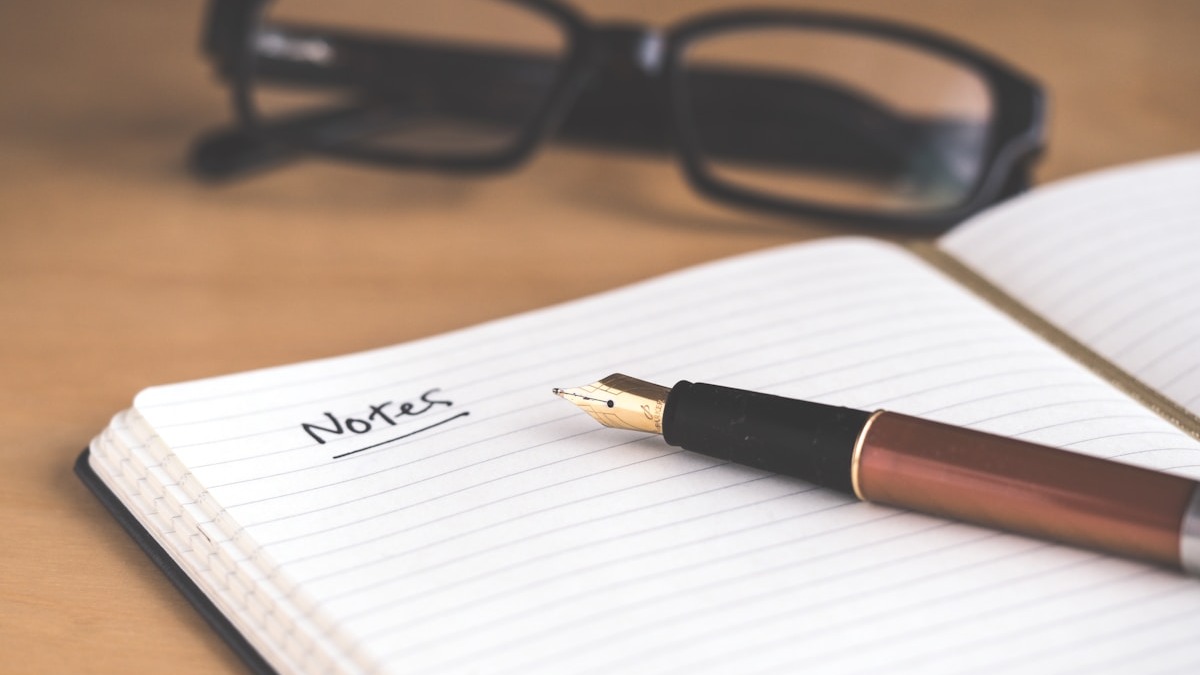 Notebook open to a handwritten page with precise formatting - analogous to what IFEval tests