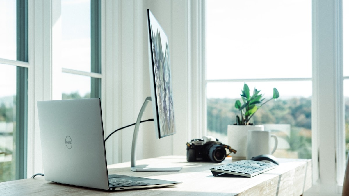 A laptop and monitor workstation setup representing the web browsing environment AI agents must navigate