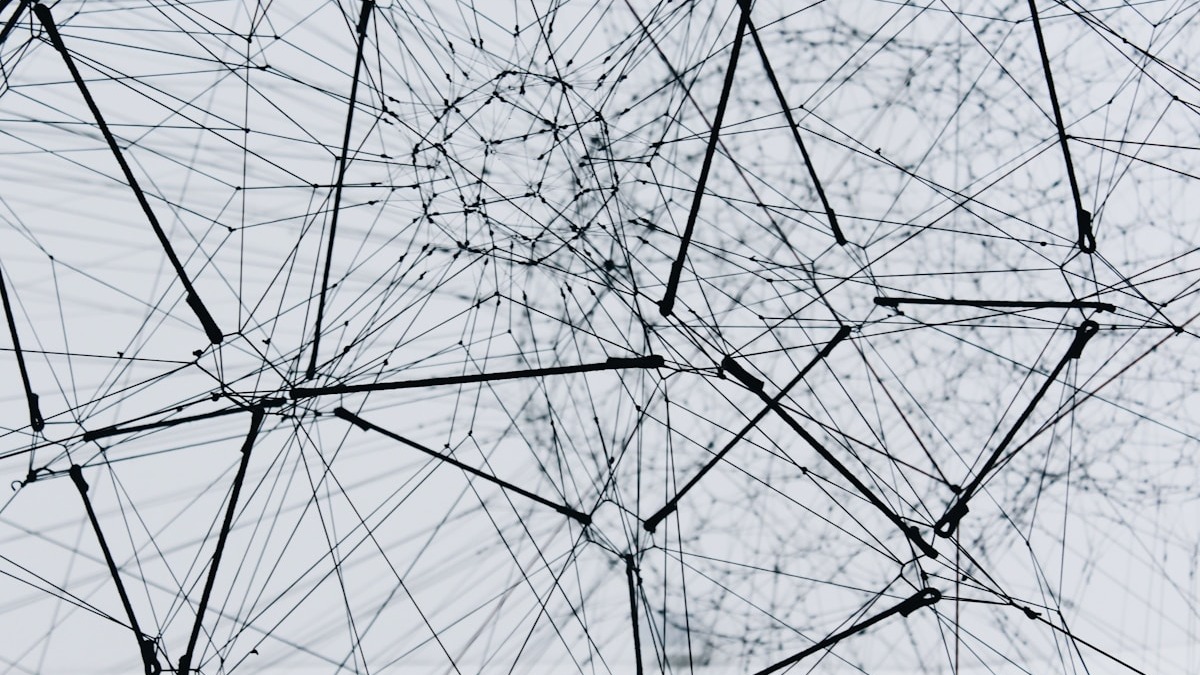 Network of interconnected nodes and edges against a light background representing distributed agent connections