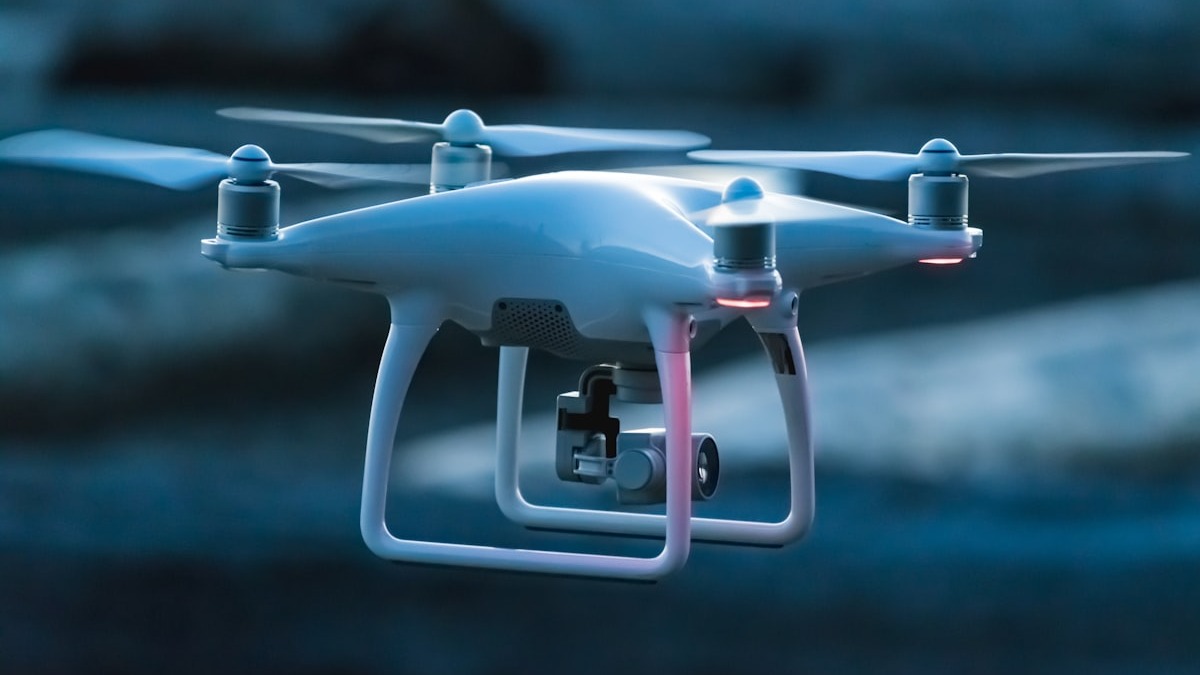 A drone hovering in flight against a dark background - OpenAI is participating in Pentagon competitions to develop voice-control technology for drone swarms