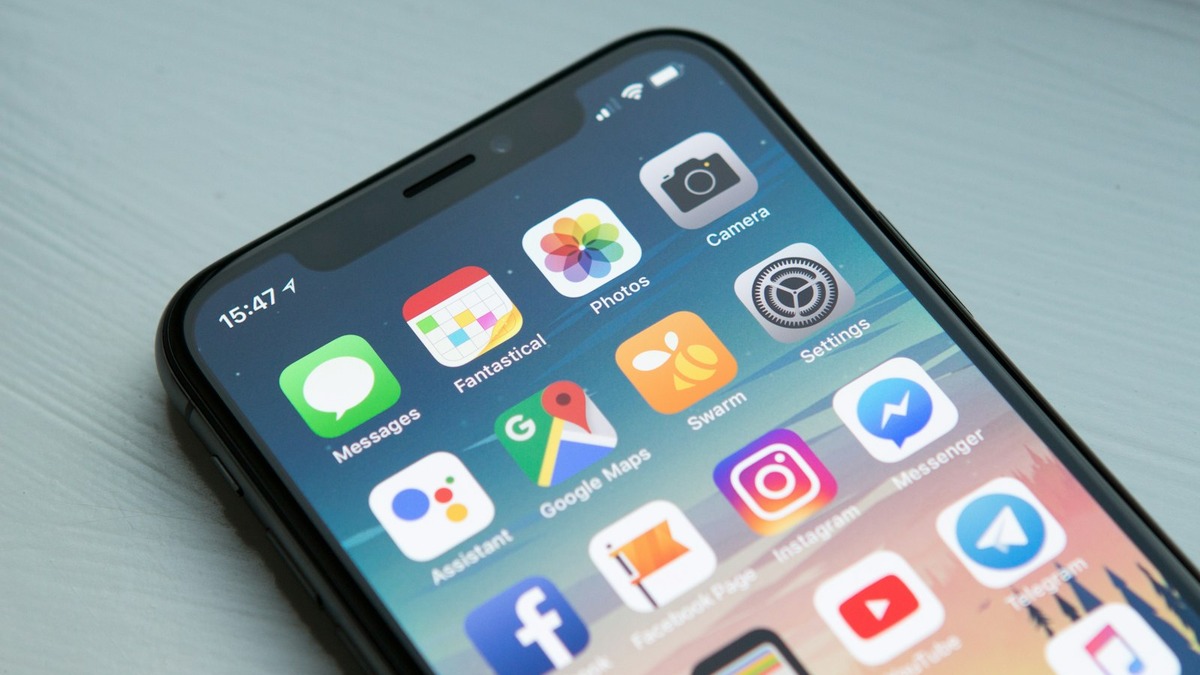 Smartphones showing various app icons on screen - Claude has risen to the top of app stores globally