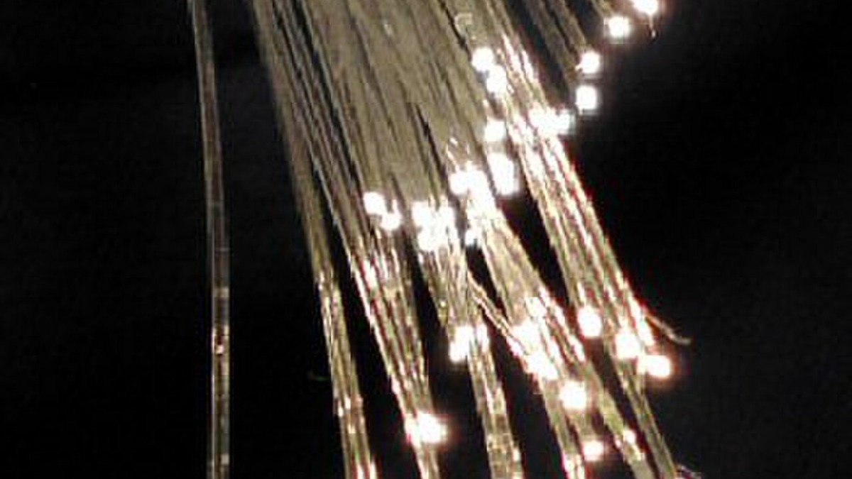 Fiber optic cables transmitting light signals - the core technology behind silicon photonics for AI data centers