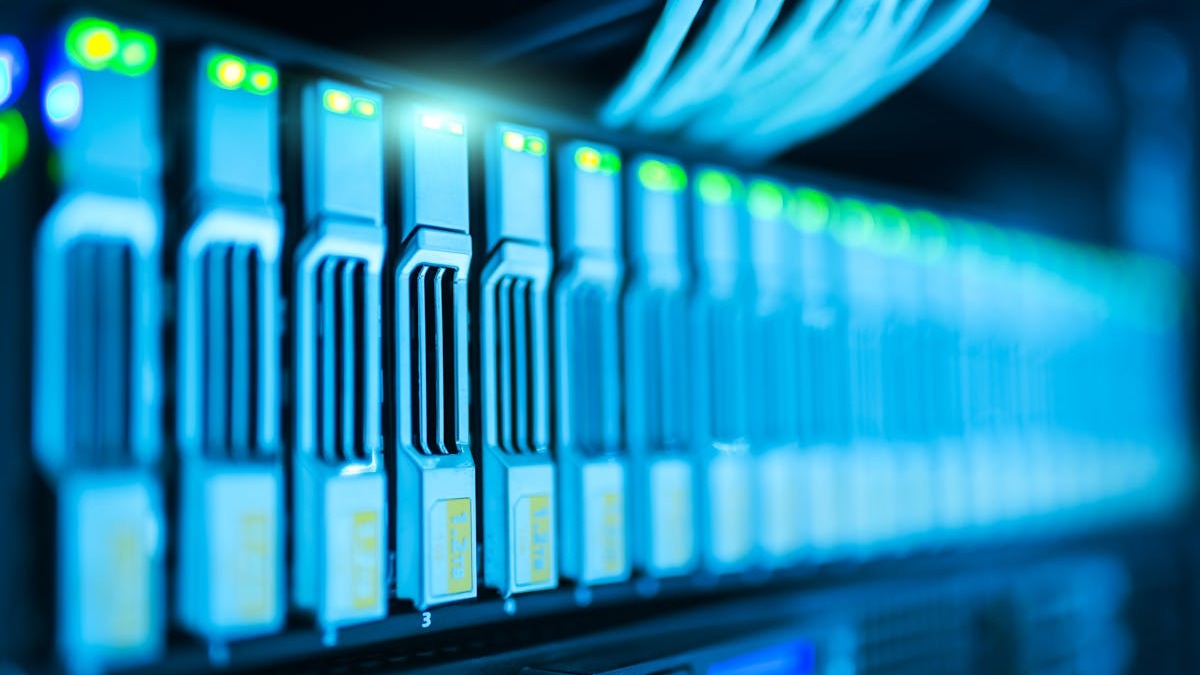 Server blades with status LEDs in a data center rack, representative of the inference infrastructure NVIDIA aims to transform