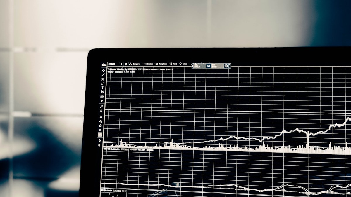 Financial data and charts spread across a desk with spreadsheets and analysis reports