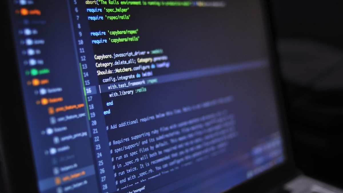Developer inspecting prompt versions and output comparisons on a monitor