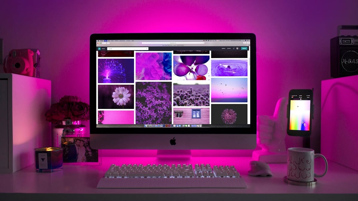 A laptop showing a digital design workspace with creative software