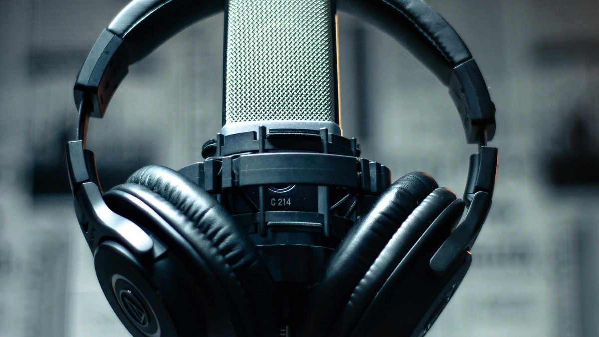 A professional condenser microphone with headset in a recording studio